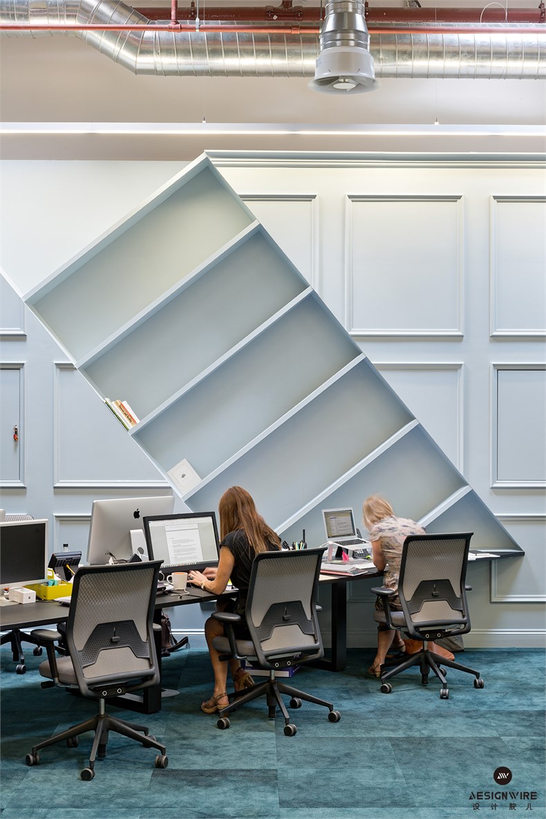 5. Blue wall panelling in directors' area with absurdist book-case at a 45 degree angle.jpg