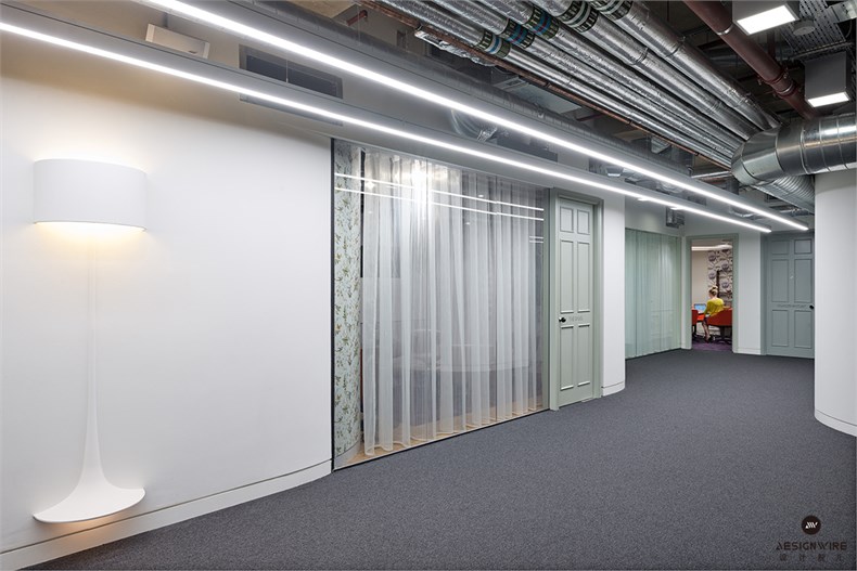 19. Lower-ground floor lighting scheme includes Flos standard light set into corridor wall between meeting rooms.jpg